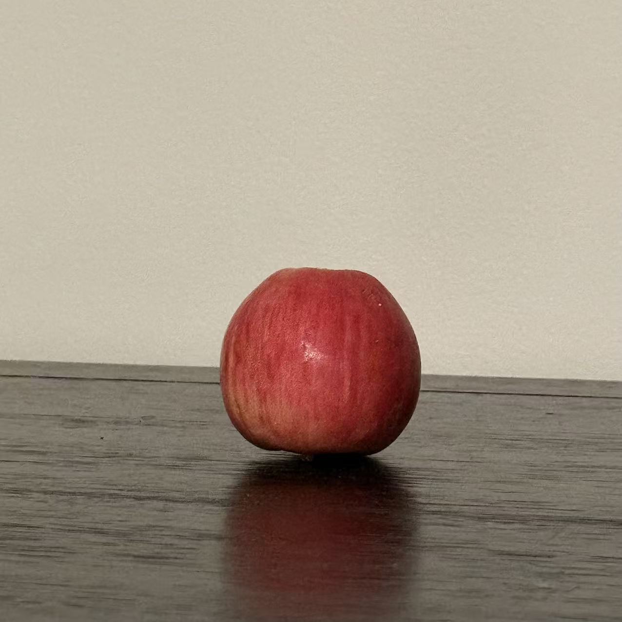 This is an apple in another perspective, its appearance is sphericity,I chose it because it's the closest thing to a sphere in my home and it's obvious at a glance that it's a sphere.